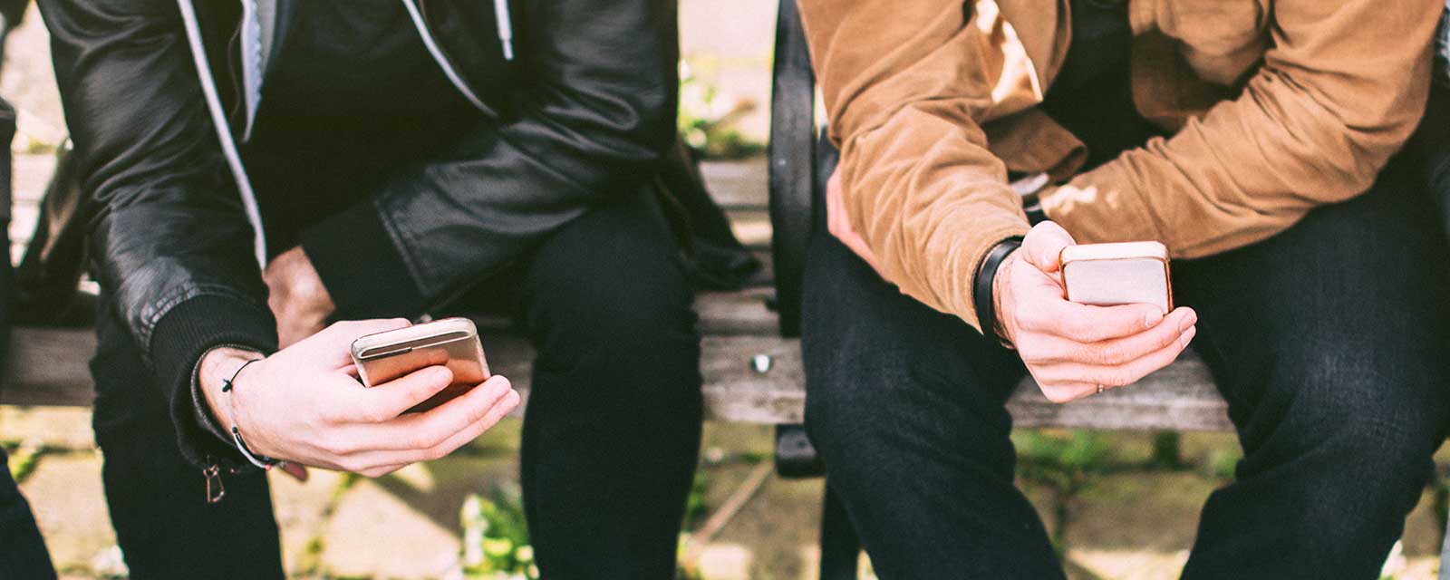 Two friends using their phones.