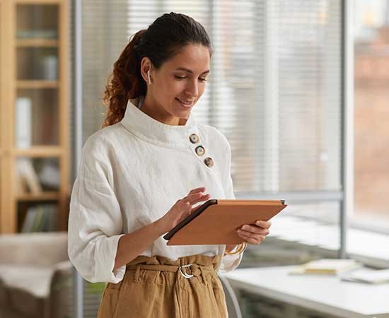 Business woman using tablet in office.