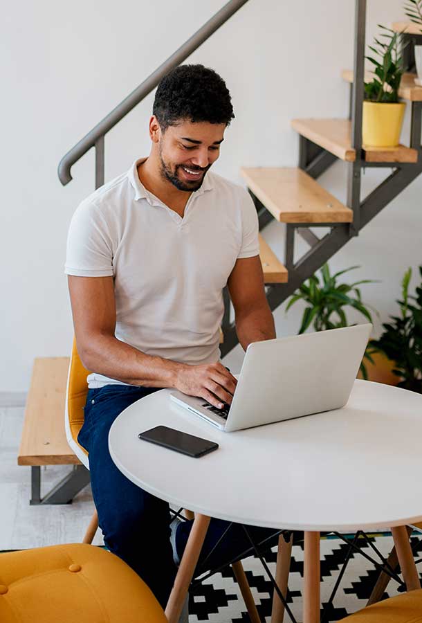 Man using laptop at home.